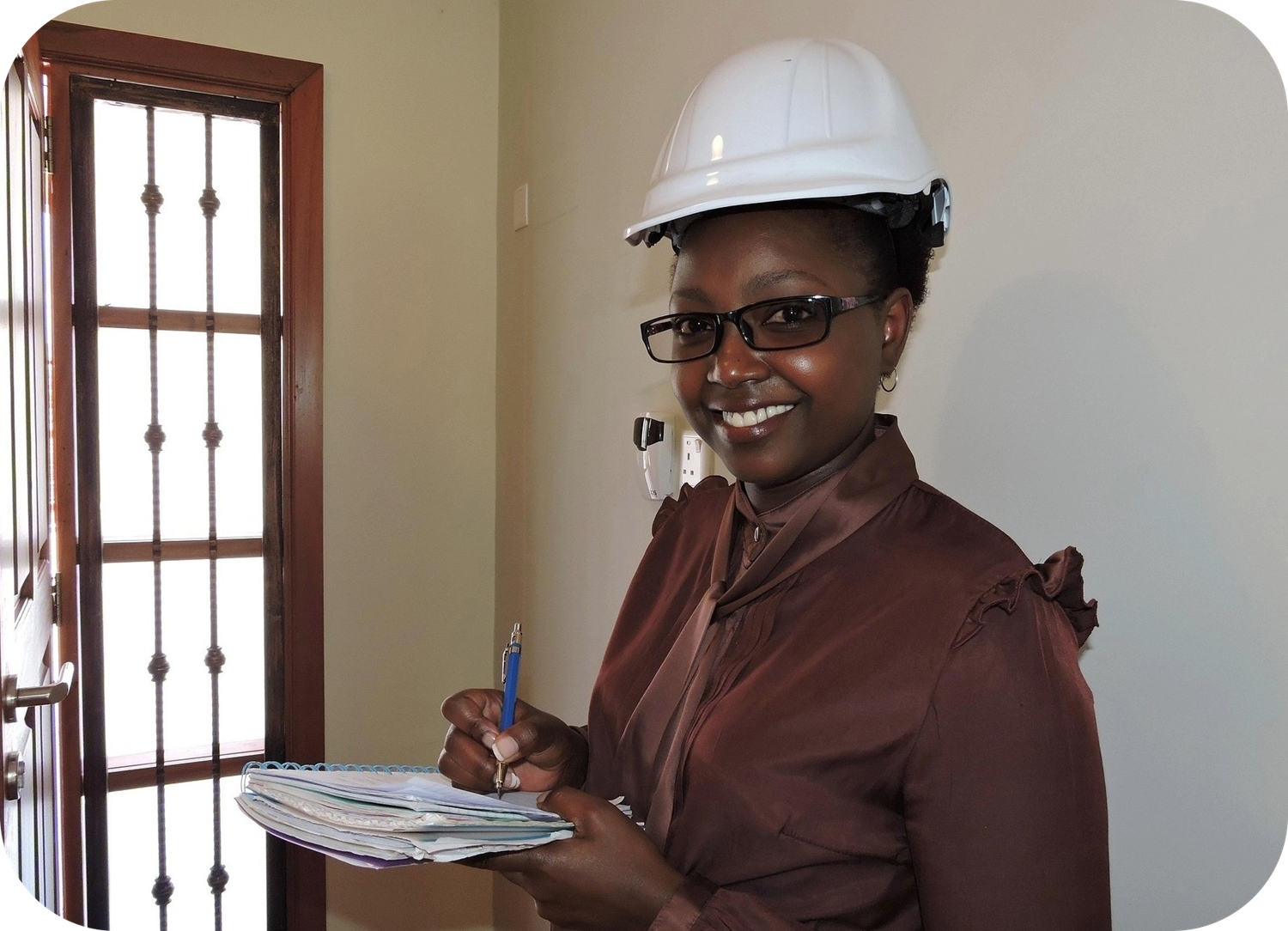 Construction site supervisor in a hard hat reviewing a project checklist