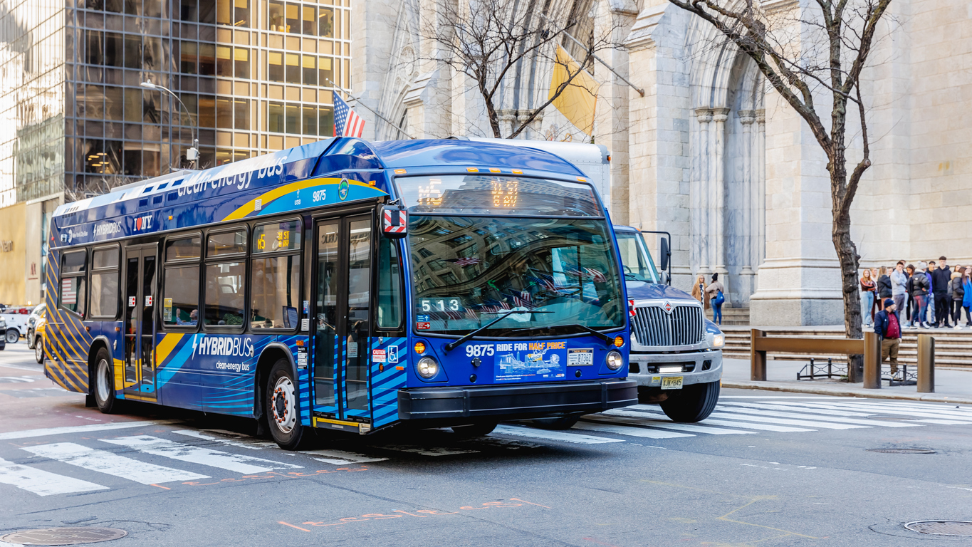 A modern public transit bus in service, representing the transportation agency served by DragonPoint custom time and attendance software